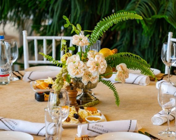 Beautifully set wedding table with elegant floral centerpiece, glassware, and cutlery in Tbilisi, Georgia.
